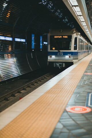 An Edmonton LRT train bound for Century Park waits at an underground station platform.